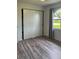 Bedroom with grey curtains and wood-look floors at 23111 Mineral Ave, Port Charlotte, FL 33954