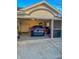 Two-car garage with storage and a car inside at 23111 Mineral Ave, Port Charlotte, FL 33954