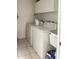 Laundry room with washer, dryer, and cabinets at 23111 Mineral Ave, Port Charlotte, FL 33954