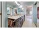 Well-lit bathroom featuring a granite countertop vanity and mirrored closet doors at 232 Southampton Ln # 259, Venice, FL 34293