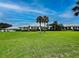 Expansive golf course clubhouse surrounded by lush green lawn at 232 Southampton Ln # 259, Venice, FL 34293