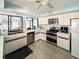 Well-lit kitchen with stainless steel appliances, tile flooring, and a sink beneath a window at 232 Southampton Ln # 259, Venice, FL 34293