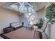 Enclosed patio with skylight features neutral furniture and potted plants at 232 Southampton Ln # 259, Venice, FL 34293