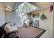 Sunlit patio with skylight, neutral furniture, and a decorative hanging plant at 232 Southampton Ln # 259, Venice, FL 34293