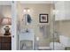 Well-lit bathroom with marble sink, framed art, and a glass-enclosed shower at 235 Capstan Dr, Placida, FL 33946