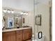 Bathroom with a double sink vanity, framed mirror, and glass walk-in shower at 235 Capstan Dr, Placida, FL 33946