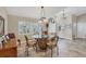 Bright dining room with unique glass table, decorative chairs, and natural light from large shuttered windows at 235 Capstan Dr, Placida, FL 33946