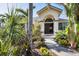 Inviting front entrance with beautiful landscaping and an arched doorway at 235 Capstan Dr, Placida, FL 33946