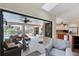 A well-lit living room leads to a covered patio and pool area, adjacent to a modern kitchen at 235 Capstan Dr, Placida, FL 33946