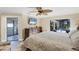 Main bedroom showcasing a large bed, dresser, and sliding door access to the pool area at 235 Capstan Dr, Placida, FL 33946