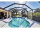 Enclosed pool area with a grill, and views of lush greenery at 235 Capstan Dr, Placida, FL 33946