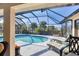 Screened-in pool area with lounge chairs offering a relaxing outdoor experience at 235 Capstan Dr, Placida, FL 33946