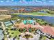 Resort-style pool, tennis courts, and clubhouse with surrounding community at 24269 Spartina Dr, Venice, FL 34293