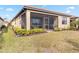 Backyard view of home with a screened patio at 24269 Spartina Dr, Venice, FL 34293