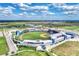 Aerial view of a baseball stadium and its surrounding landscape at 24269 Spartina Dr, Venice, FL 34293