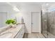 Double vanity bathroom with granite countertop and large shower at 24269 Spartina Dr, Venice, FL 34293