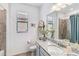 Bathroom with granite countertop, modern vanity, and shower at 24269 Spartina Dr, Venice, FL 34293