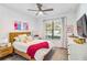 Cozy bedroom featuring a wooden bed frame and plenty of natural light at 24269 Spartina Dr, Venice, FL 34293