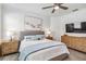 Serene bedroom boasting a plush bed, nightstands and large artwork at 24269 Spartina Dr, Venice, FL 34293