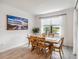 Bright dining room with wooden table and chairs, and large windows at 24269 Spartina Dr, Venice, FL 34293