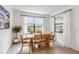 Spacious dining area features a wooden table, chairs, and natural light at 24269 Spartina Dr, Venice, FL 34293