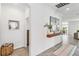 Bright and airy entryway with wood shelf and tile flooring at 24269 Spartina Dr, Venice, FL 34293