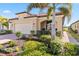 One-story home with a welcoming porch and nicely manicured landscaping at 24269 Spartina Dr, Venice, FL 34293