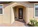 Front entry with a dark brown door and a brick walkway at 24269 Spartina Dr, Venice, FL 34293