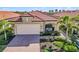 Tan house with tile roof and palm trees at 24269 Spartina Dr, Venice, FL 34293