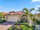 Tan house with tile roof and palm trees at 24269 Spartina Dr, Venice, FL 34293