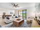 Bright living room with comfy seating, large sliding doors, and view of backyard at 24269 Spartina Dr, Venice, FL 34293