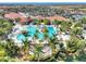 Large resort-style pool surrounded by palm trees and lounge chairs at 24269 Spartina Dr, Venice, FL 34293