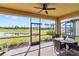 Screened patio with seating area and pond view at 24269 Spartina Dr, Venice, FL 34293