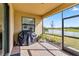 Screened patio with grill and pond view at 24269 Spartina Dr, Venice, FL 34293