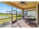 Screened patio with seating area and pond view at 24269 Spartina Dr, Venice, FL 34293