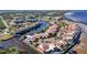 Aerial view of waterfront community with private docks, lush landscaping, and tennis courts at 25188 Marion Ave # C206, Punta Gorda, FL 33950