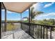 Screened balcony overlooking lush landscaping and partial water view at 25188 Marion Ave # C206, Punta Gorda, FL 33950