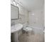 Clean bathroom with white tub and vanity at 25188 Marion Ave # C206, Punta Gorda, FL 33950