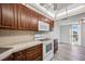 Kitchen features wood cabinets and white appliances at 25188 Marion Ave # C206, Punta Gorda, FL 33950