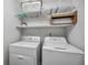 Laundry room complete with washer, dryer, and shelving at 25188 Marion Ave # C206, Punta Gorda, FL 33950