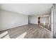 Bright living room with grey wood-look floors and plenty of natural light at 25188 Marion Ave # C206, Punta Gorda, FL 33950