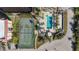 Aerial view of resort-style amenities including a swimming pool and tennis courts at 25188 Marion Ave # C206, Punta Gorda, FL 33950