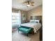 Cozy bedroom with queen-size bed and teal accent bench at 254 Mark Twain Ln, Rotonda West, FL 33947