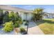 Inviting front entrance with lush tropical landscaping and a stylish blue door at 254 Mark Twain Ln, Rotonda West, FL 33947