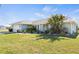 Well-maintained single-story home with arched windows and lush landscaping on a sunny day at 254 Mark Twain Ln, Rotonda West, FL 33947