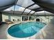 Relaxing kidney-shaped pool with covered patio area at 254 Mark Twain Ln, Rotonda West, FL 33947