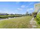 Scenic backyard with waterfront access, lush lawn, and peaceful canal views at 254 Mark Twain Ln, Rotonda West, FL 33947