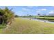 Picturesque waterfront view from the backyard with lush landscaping and tranquil canal at 254 Mark Twain Ln, Rotonda West, FL 33947