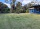 Large backyard with grassy lawn and a fire pit at 2933 Vizza Ln, North Port, FL 34286