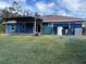 House back view, with covered patio and grassy lawn at 2933 Vizza Ln, North Port, FL 34286